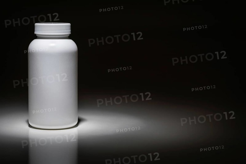 Blank white bottle ready for your text under spot light