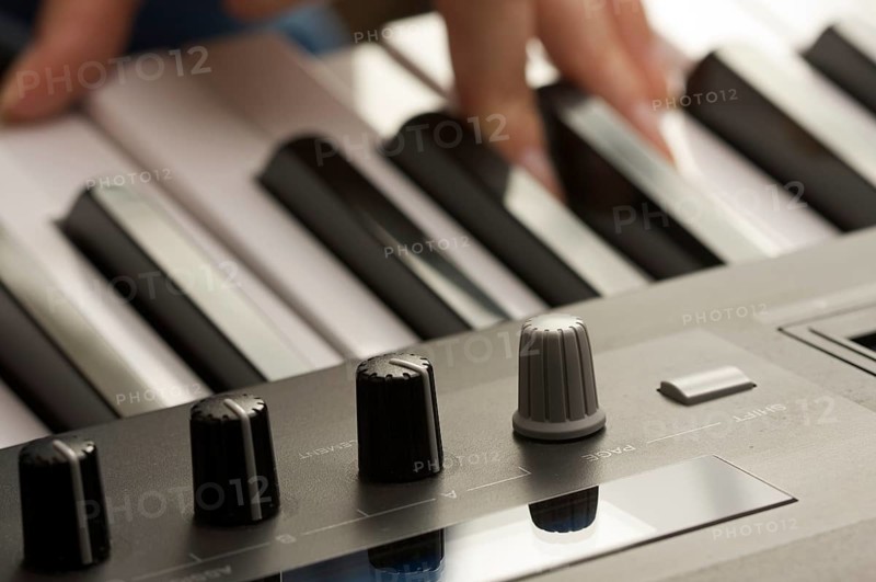 Woman's fingers on digital piano keys