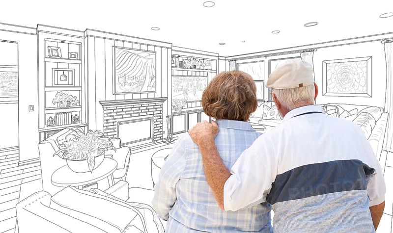 Curious senior couple looking over custom living room design drawing