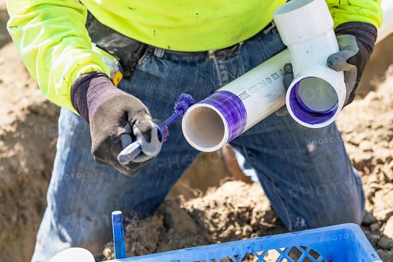 Plumber applying pipe cleaner