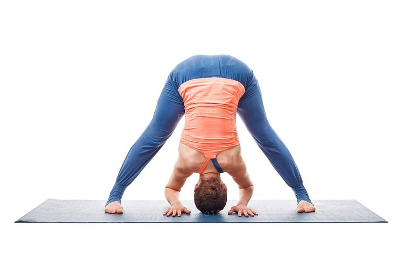 Beautiful sporty fit woman practices Ashtanga Vinyasa yoga asana Prasarita padottanasana A