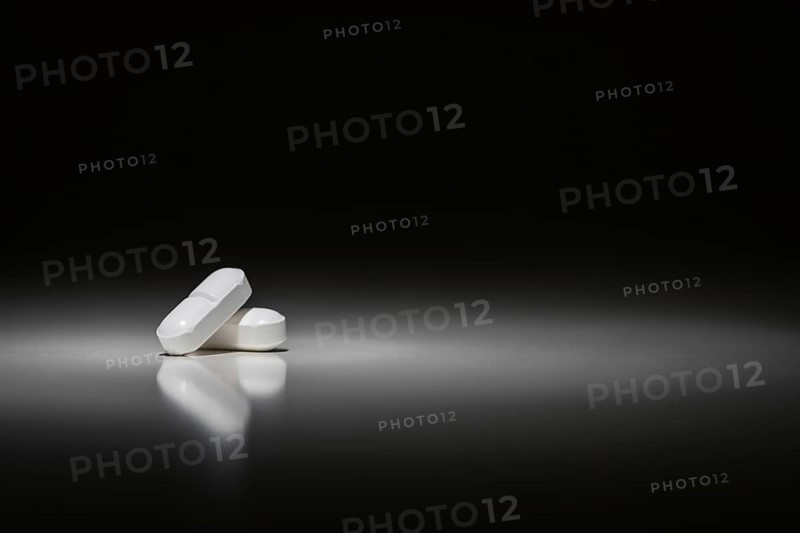 Hydrocodone prescription pills under spot light