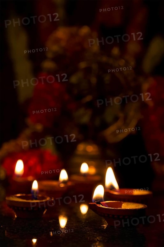 Diwali lights oil candles with Shiva Nataraja in the background for Maha Shivaratri