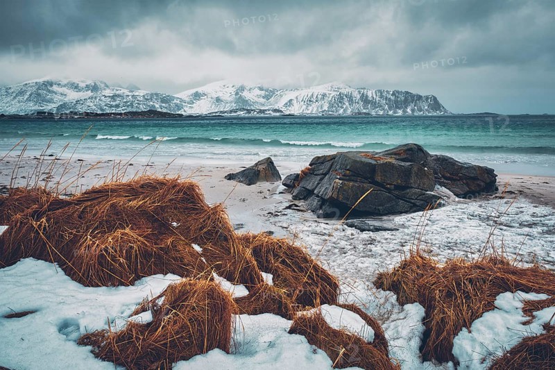 Waves of Norwegian sea on rocky beach of fjord. Ramberg beach
