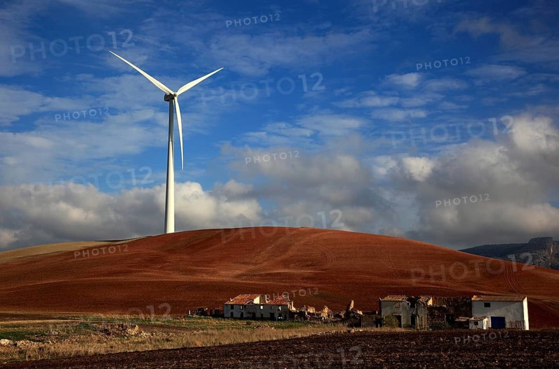 Windmill and dilapidated houses in front of it