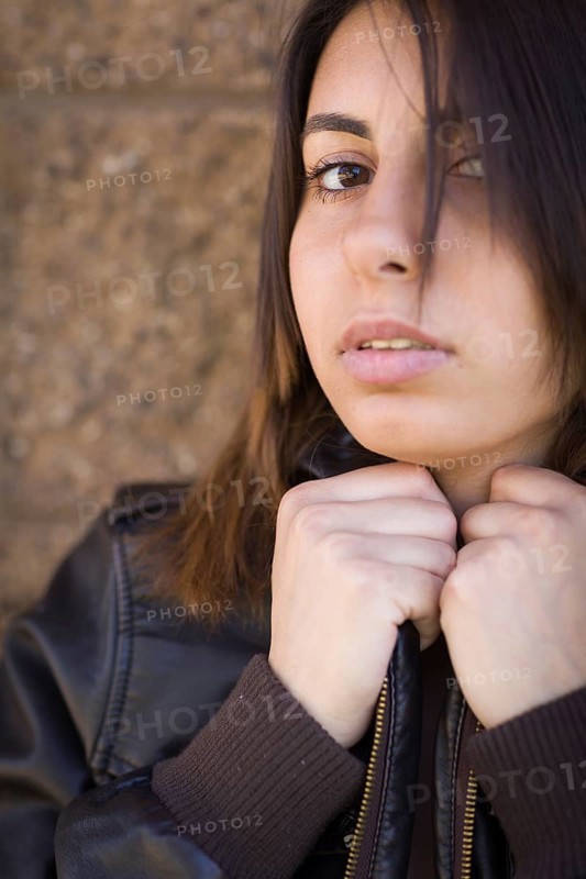 Beautiful meloncholy mixed-race young woman portrait outside