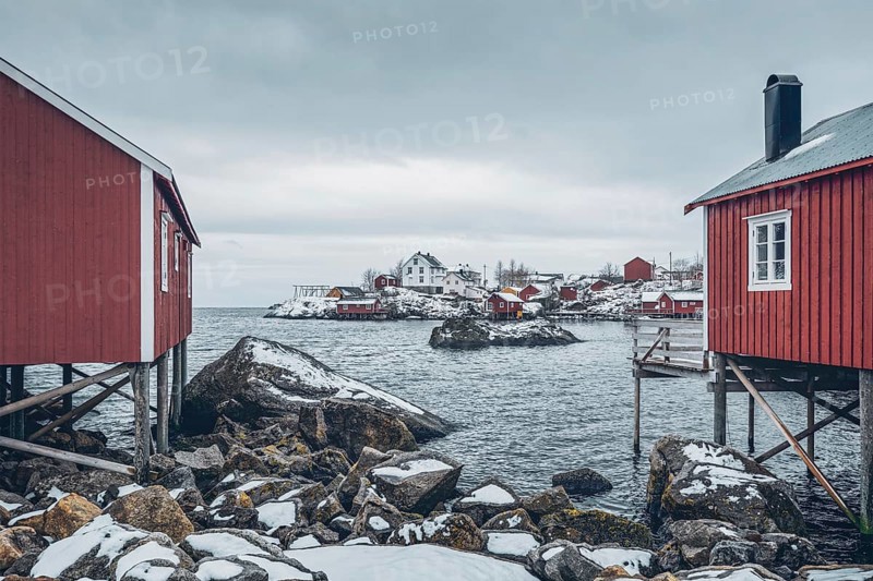 Nusfjord authentic traditional fishing village with traditional red rorbu houses in winter in Norwegian fjord. Lofoten islands