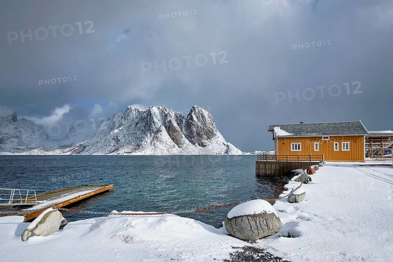 Yellow traditional rorbu house in Sakrisoy fishing village in winter on Lofoten Islands
