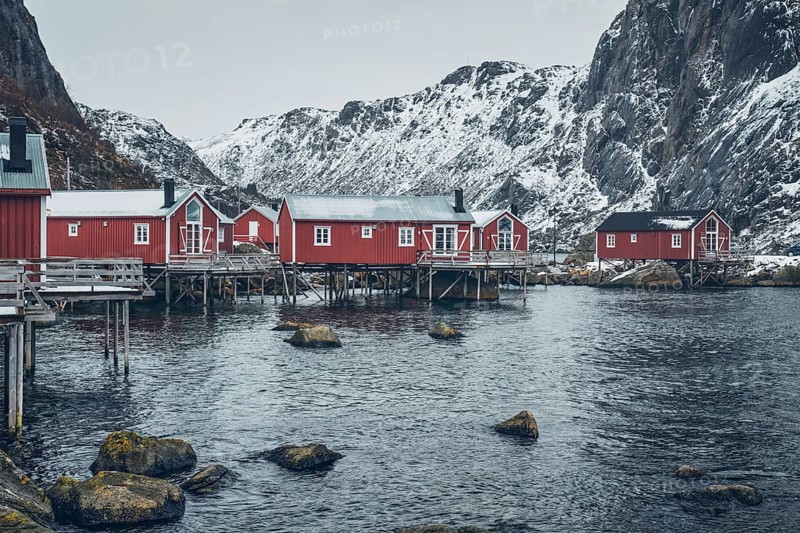 Nusfjord authentic traditional fishing village with traditional red rorbu houses in winter in Norwegian fjord. Lofoten islands
