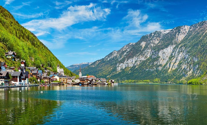 Swan in lake against Hallstatt village on Hallstatter See in Austrian alps. Salzkammergut region