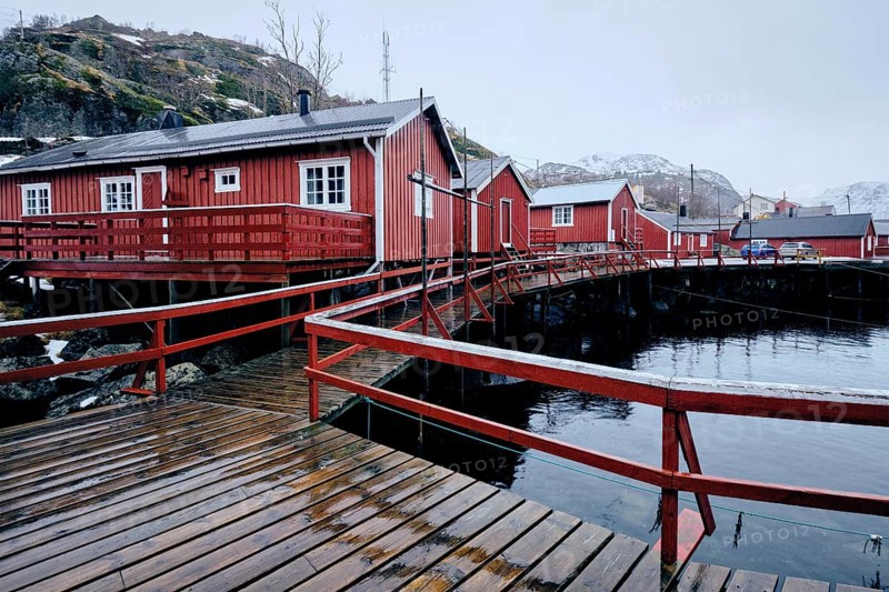 Nusfjord authentic traditional fishing village with traditional red rorbu houses in winter in Norwegian fjord. Lofoten islands