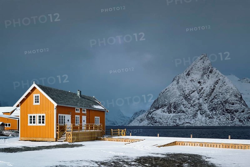 Yellow traditional rorbu house in Sakrisoy fishing village in winter on Lofoten Islands