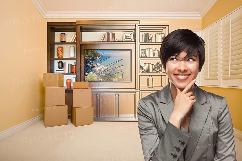 Young mixed-race female looking to the side in room with drawing of entertainment unit on wall