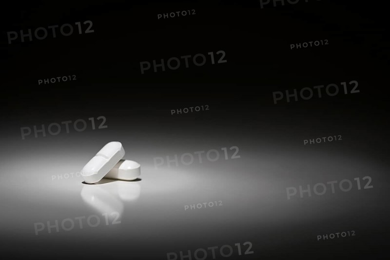 Hydrocodone prescription pills under spot light