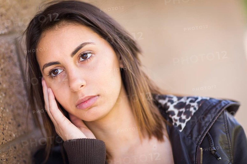 Beautiful meloncholy mixed-race young woman portrait outside