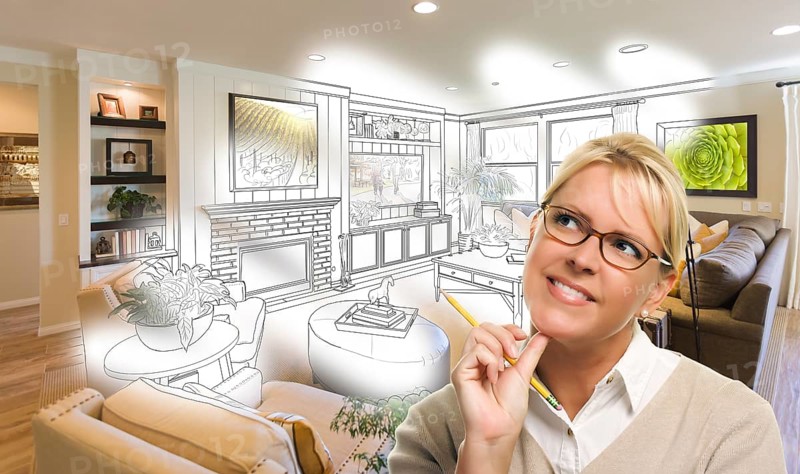 Woman with pencil over living room design drawing and photo combination