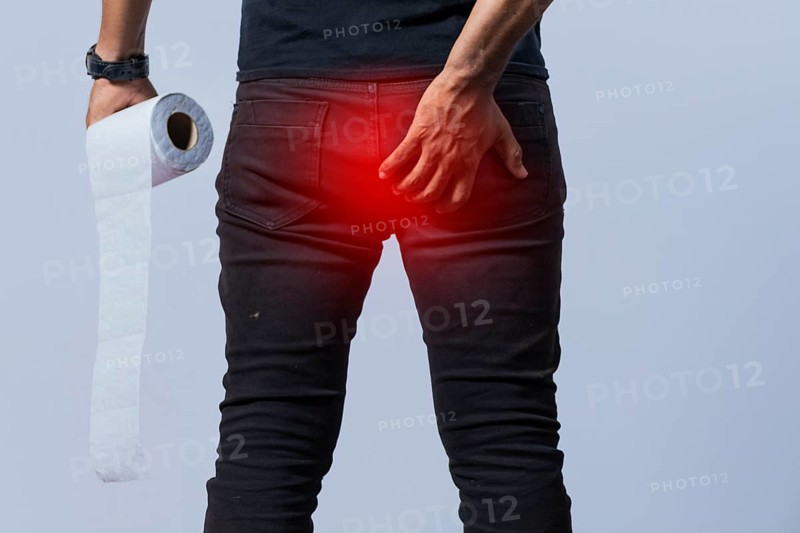 People with toilet paper in hand touching his buttock