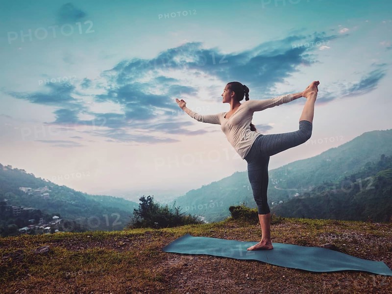 Woman doing yoga asana Natarajasana