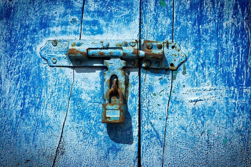 Old latch with padlock on the door