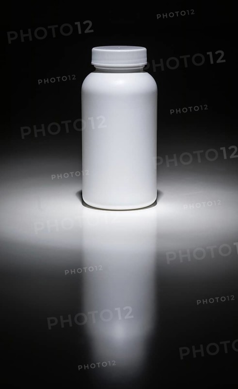 Blank white bottle ready for your text under spot light