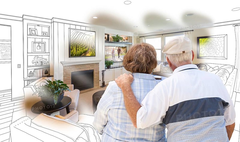 Curious senior couple looking over custom living room design drawing photo combination