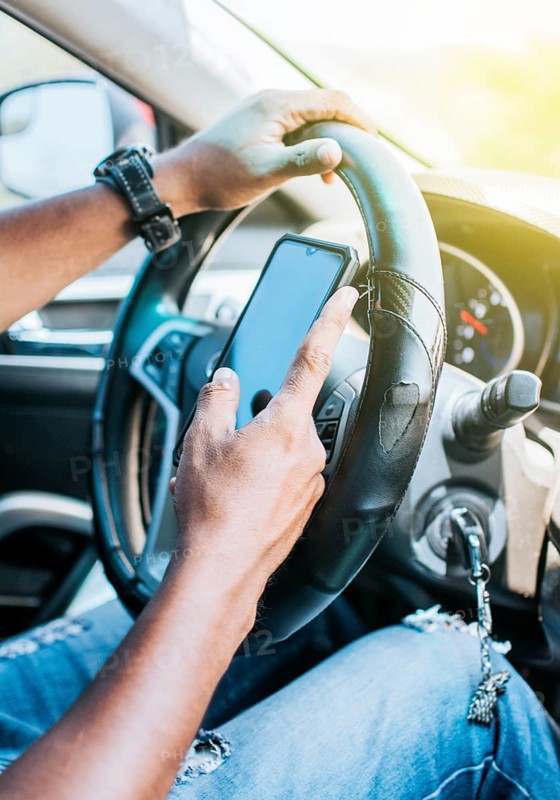 Close up of driver hands using his phone