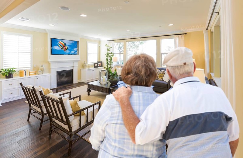 Affectionate senior couple overlooking A beautiful custom living room