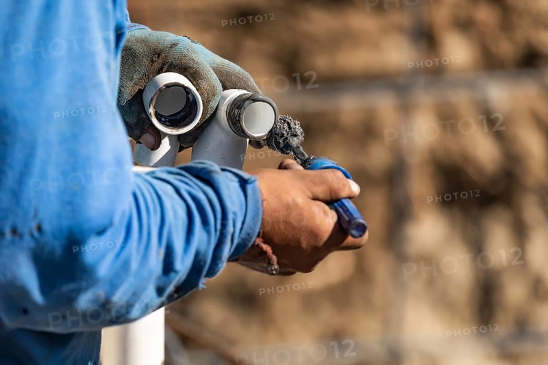 Plumber applying pipe cleaner