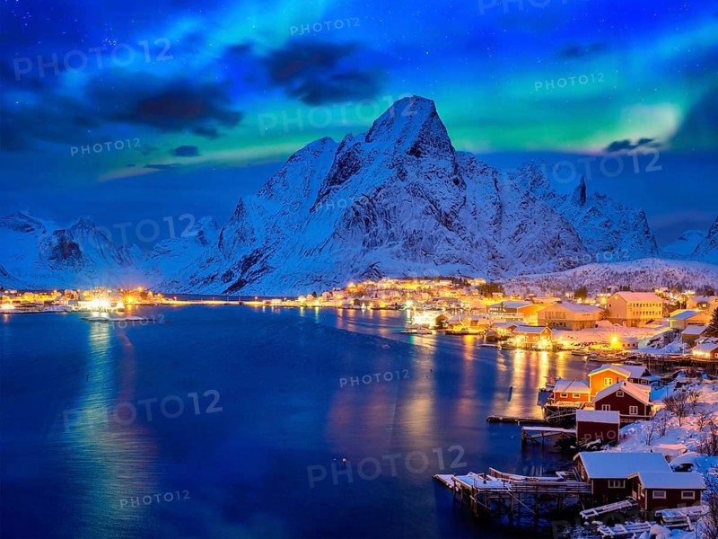 Reine village illuminated at night with Aurora Borealis. Lofoten islands