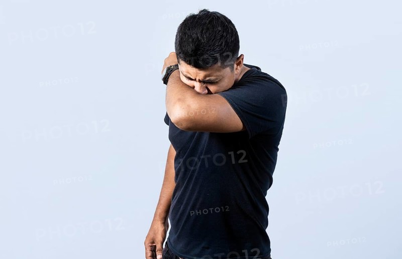 People sneezing with his elbow
