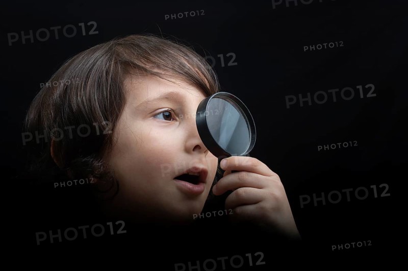 Boy with magnifying glass ready to explore