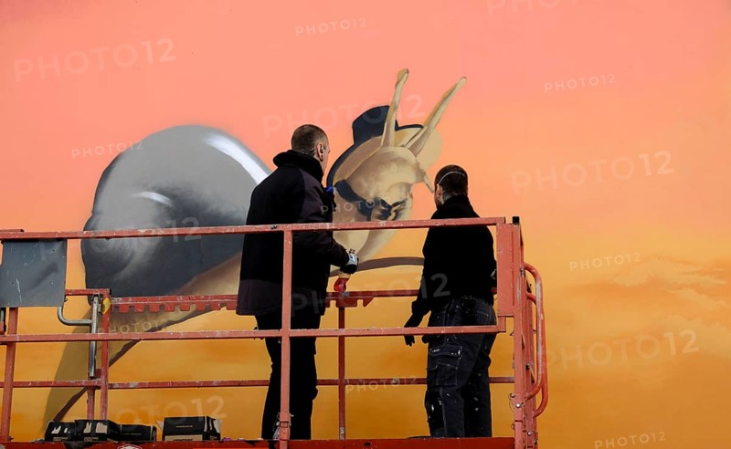 Graffity artist on a lifting platform during a commissioned work