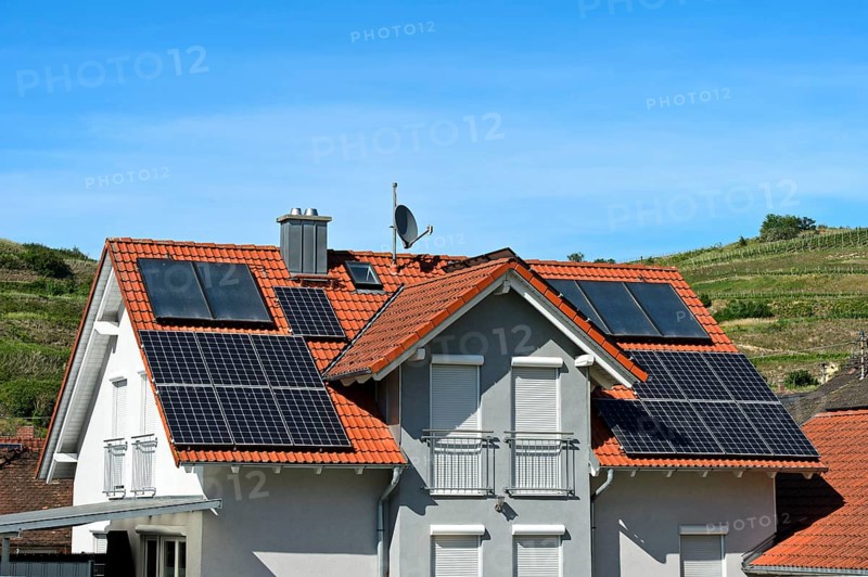 Single-family house with thermal solar system for hot water and solar panels for electricity generation on the roof