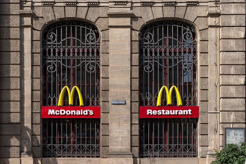 Mc Donald logos on the windows of a historic post office building