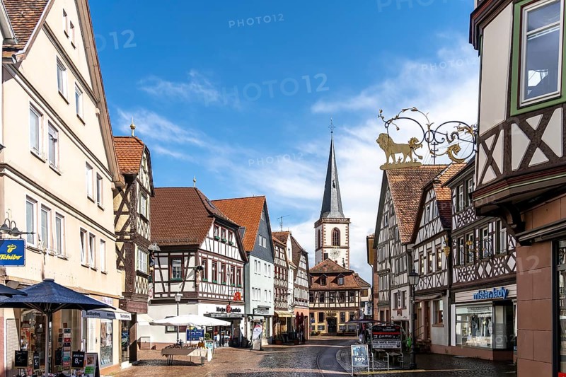 View of the pedestrian zone with church in the old town of Lohr am Main with half-timbered houses