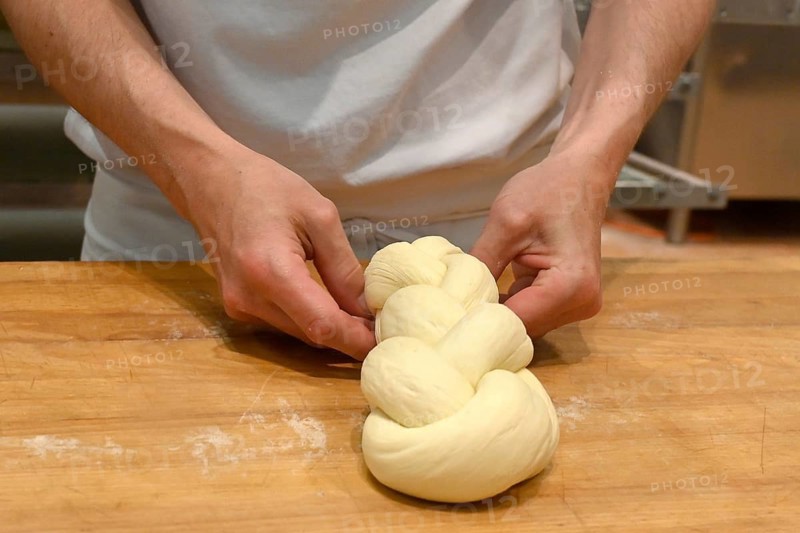 Bakers plaiting butter plait