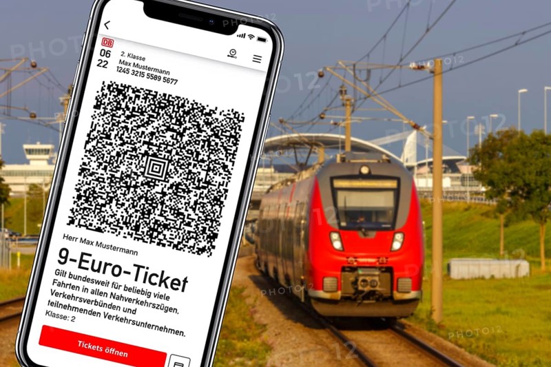 9-euro ticket on mobile phone with regional train Photo montage in Munich