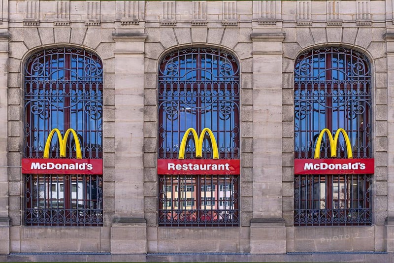 Mc Donald logos on the windows of a historic post office building