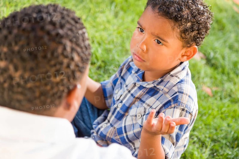 Happy african american father and mixed-race son playing at the park