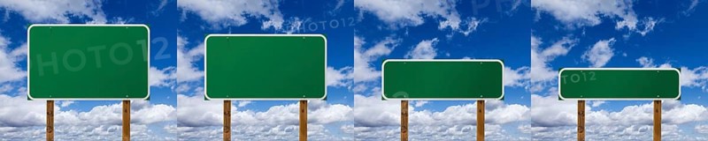 Set of different sized blank green road signs over clouds and blue sky