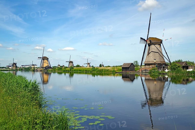 Historic windmills reflected in a canal