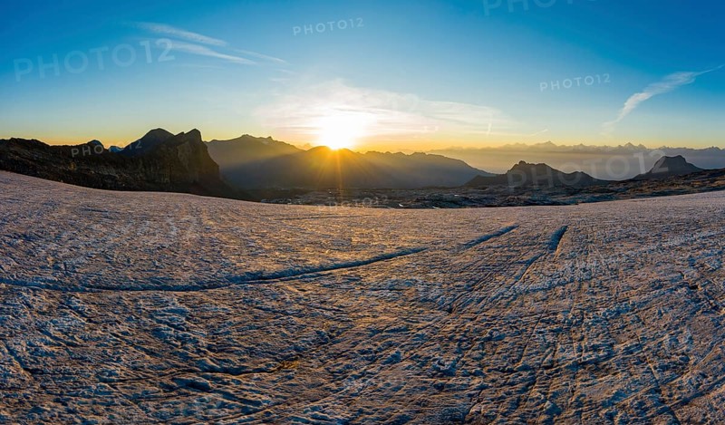 Aerial view over the Zanfleuron glacier with rising sun