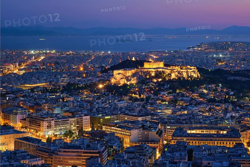 Parthenon Temple on hill is the antique tourist landmark at the Acropolis of Athens and ancient European civilization architecture on Aegean sea coast. Dusk view from Mount Lycabettus