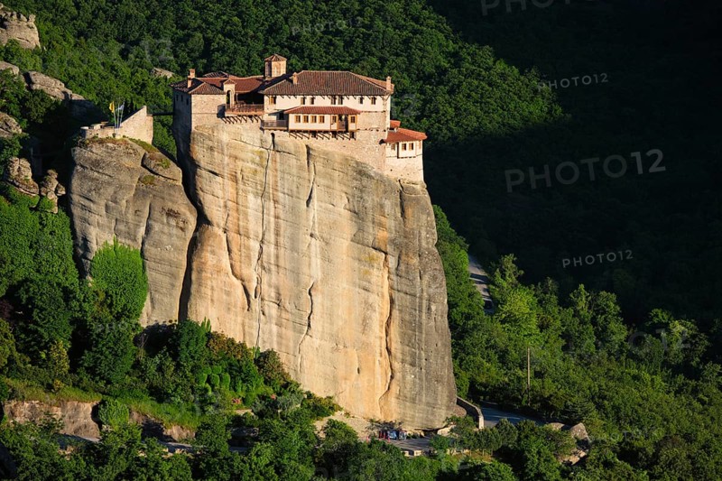 Monastery of Rousanou perched on a cliff in famous greek tourist destination Meteora in Greece on sunset with scenic landscape