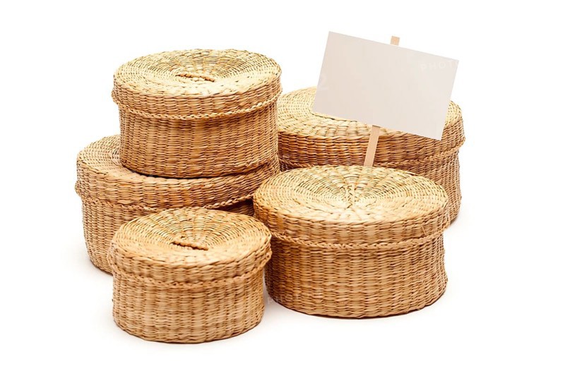 Various sized wicker baskets with blank sign isolated on white