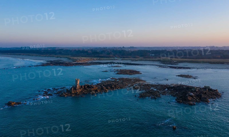 Aerial view of rock formations in the sea in front of the sandy beach Ker Emma and dunes Keremma shortly in front of sunset