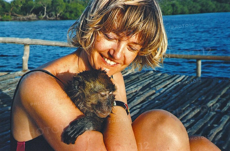 Woman holding wet baboon