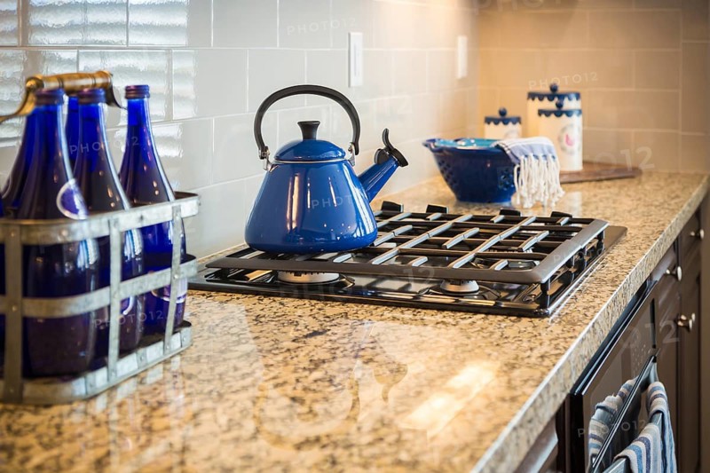 Beautiful marble kitchen counter and stove with cobalt blue decor