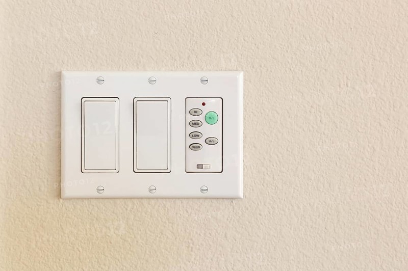 Light switches and fan control on wall of home