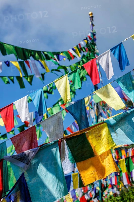 Buddhist prayer flags lungta with Om Mani Padme Hum Buddhist mantra prayer meaning Praise to the Jewel in the Lotus on kora around Tsuglagkhang complex